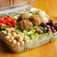 Mediterranean Salad · Roasted red peppers, artichoke hearts, mixed olives, garbanzo beans, and falafel balls over ...