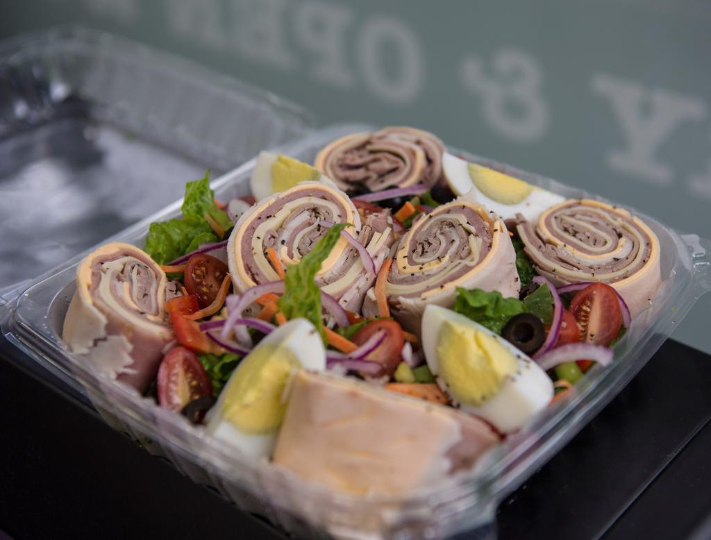 Chefs Salad · Romaine lettuce with roast beef ham, turkey and Swiss pinwheel tomato, onions, cucumber and carrot.