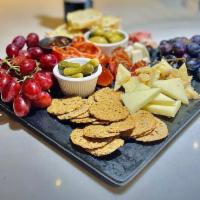 Antipasto Platter · Cheeses and meats served with olives and rustic bread.