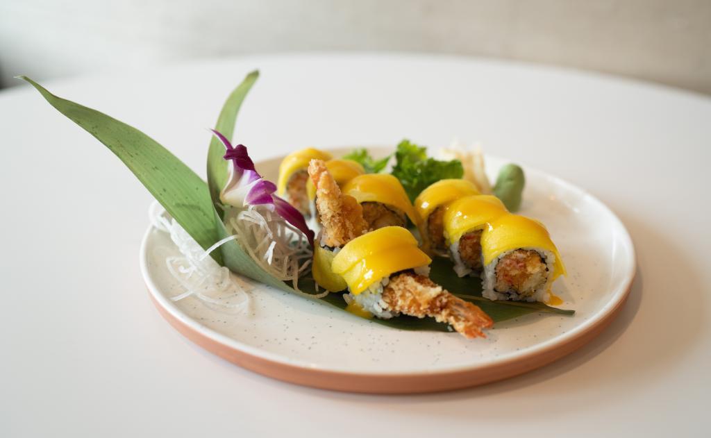 S16. Long Beach Roll · Shrimp tempura and spicy crab inside, topped with mango and mango sauce.