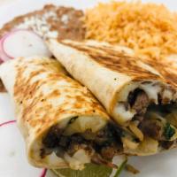 Quesadilla · Flour tortilla with choice of meat, rice and beans.
