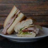 Swiss and Turkey Sandwich · Comes with lettuce, tomato, and mustard. Served with choice of bread.