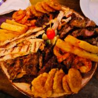 Picadera de Carnes · Mixed grilled meat platter with churrasco (skirt steak), pollo (chicken), chuleta (pork chop...