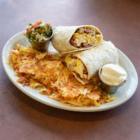 Breakfast Burrito · Scrambled eggs, sausage, cheddar and bacon in a flour tortilla with sour cream and salsa.