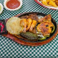 Mix Fajitas · Grilled chicken, steak fajitas, and shrimp with onion and bell pepper.