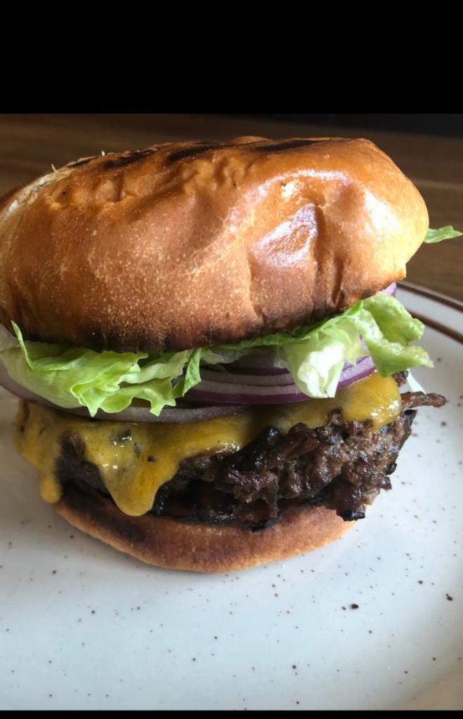 Brisket Burger W/ Fries · 1/2 lb blend of our burnt brisket ends and Angus beef meshed into the perfect patty, served on a brioche bun with cheddar, red onion, and lettuce.  Served with Fries