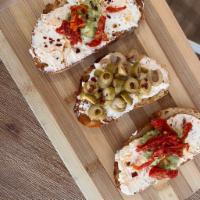 Feisty Labneh Tartlets  · Toasted Sourdough 
Spicy Labneh 
Avocado 
Sundried Tomatoes 
Chopped Green Olives 
Red Peppe...
