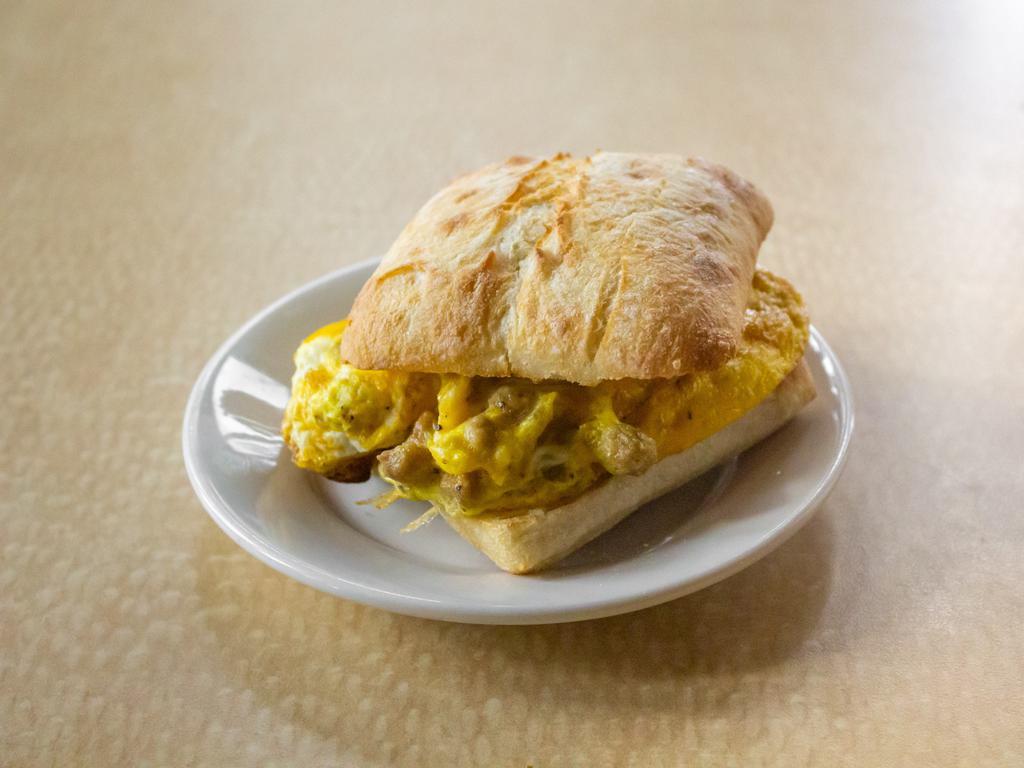 The Classic Breakfast Sandwich · Choice of turkey bacon, deli ham, deli turkey, or sausage crumbles inside a 2 Real egg souffle (no frozen stuff), w/real cheddar and 1872 breakfast sauce. 