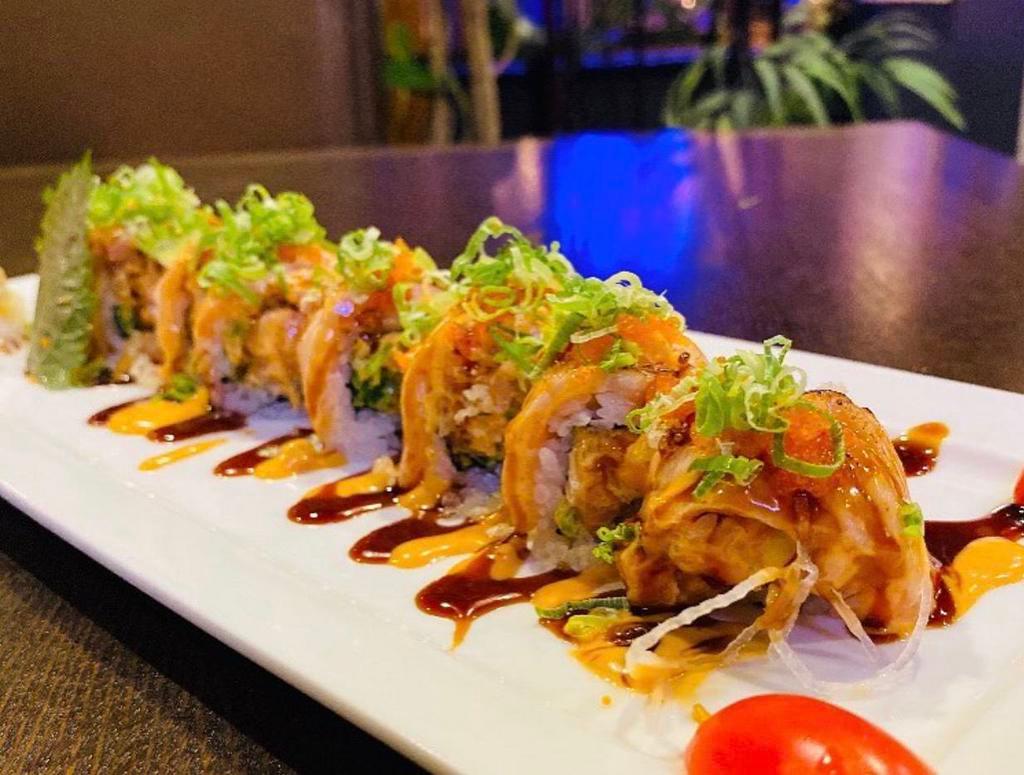 Crazy Salmon Roll  · Spicy salmon roll on top with seared salmon, spicy mayo and tobiko crunchy, eel sauce.