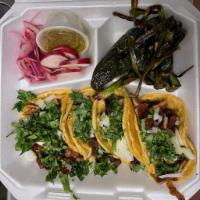 Adobada Taco · Tacos de puerco marinado en adobo rojo de chile. Pork tacos marinated in a mix of spices in ...