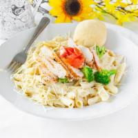 Chicken Alfredo Pasta · Penne pasta a creamy Alfredo sauce with grilled chicken breast broccoli and tomatoes sprinkl...