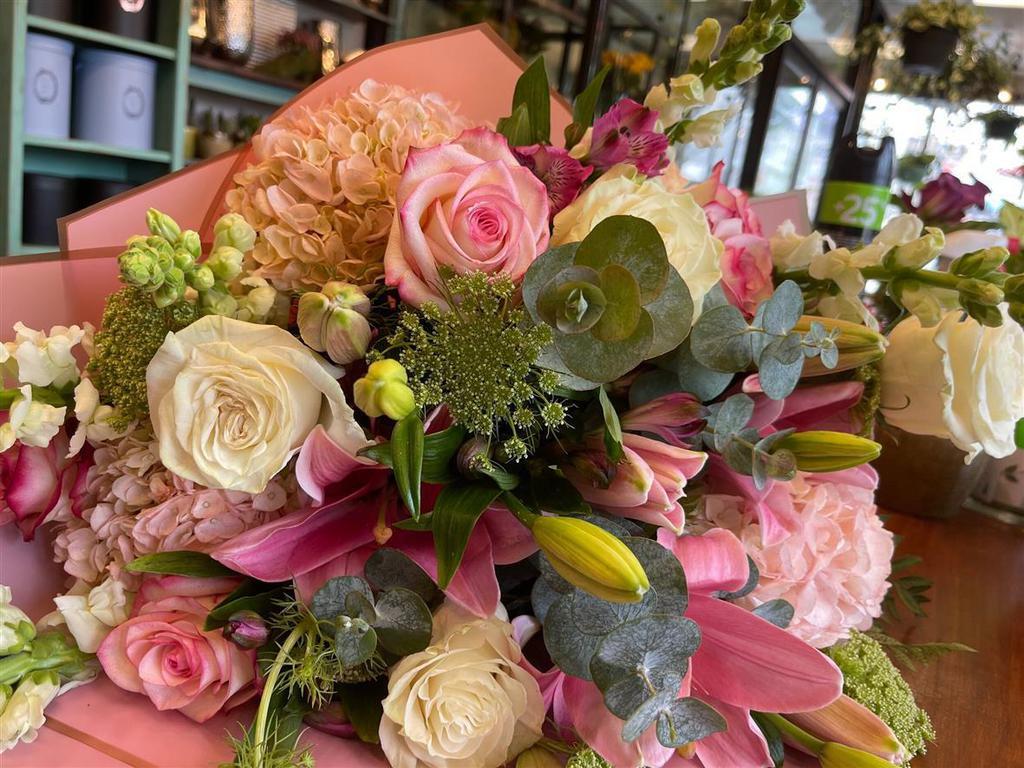Sweet Dreams · A European-styled hand-tied bouquet, make with blush pink roses eucalyptus lilies hydrangeas, and other seasonal flowers to complete that unique look.