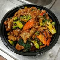 Beef with Broccoli · Sliced beef sauteed with broccoli and carrots in brown sauce. Served with small white rice.