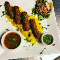 Lamb Seekh Kebab · Marinated in traditional tandoori seasonings and grilled in a clay oven.