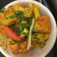 Aloo Gobi Masala · Cauliflower, ginger, garlic and tomato in a cumin-based spice. Vegan.