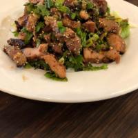 Num Tok Kor Moo Yang Salad - E Sarn Style · Marinated pork shoulder grilled, mint leaves, cilantro, tomato, green onion, shallots and ro...