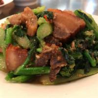 Signature Crispy Pork Belly with Green Kana · Homemade crispy pork belly stir fried with fresh garlic, Thai chili and green Chinese brocco...