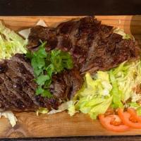 Tiger Cry - Grilled Steak · Marinated steak in Thai herb and spices, grilled to tender and juicy. Served with steamed ja...