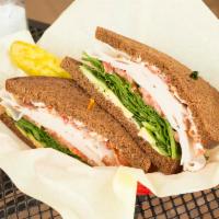 The Penguin Sandwich · Turkey, bacon, avocado, spinach, tomato and mayo on sliced squaw bread.