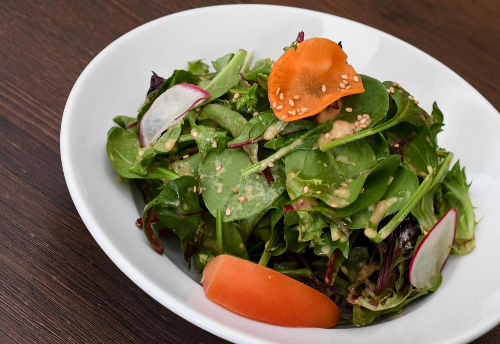 Green Salad · Organic baby greens and tomatoes tossed with our house ginger dressing. Vegetarian.