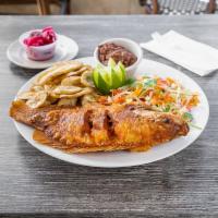 Pescado Frito · Fried fish with rice, beans, and iceberg lettuce salad.