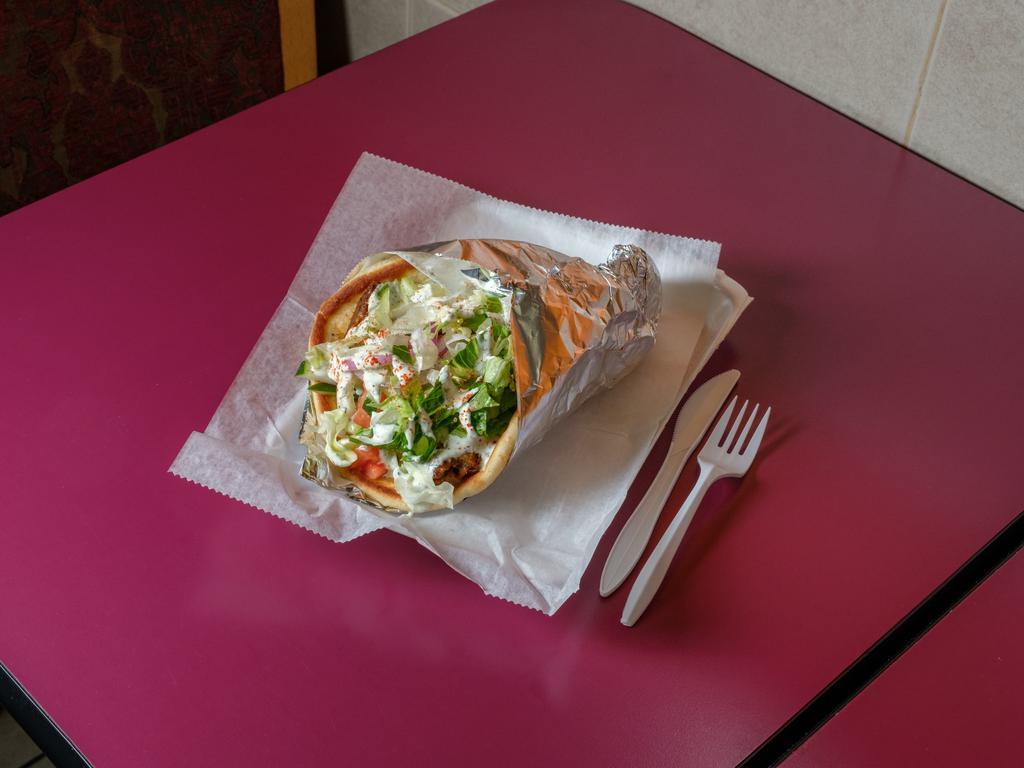 Falafel Gyro · Falafel gyro served on a pita bread with lettuce tomatoes and cucumbers and your choice of sauces.