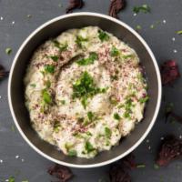 Baba-Ghanoush · A Levantine dish of mashed cooked eggplant mixed with tahina, olive oil, and various seasoni...