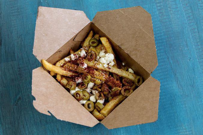 Greek Fries · Our deliciously crunchy fries topped with feta cheese, olives, and sumac.