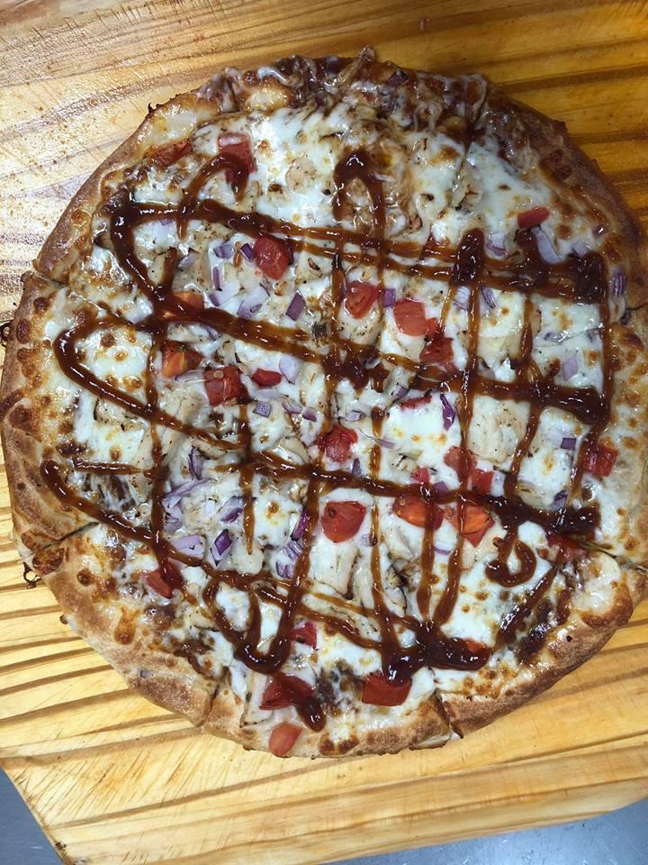 Barbeque Chicken Pizza · Grilled chicken, red onions, Roma tomatoes, fresh cilantro and mozzarella with BBQ sauce. 