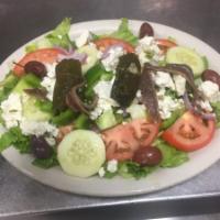 Greek Salad · Mixed greens with tomato, cucumbers, peppers, onions, olives, feta cheese and stuffed grape ...