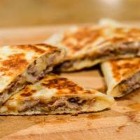 Steak Quesadilla · Thin tortilla jam-packed with steak, cheese, and veggies. Cooked over a hot griddle for a bi...