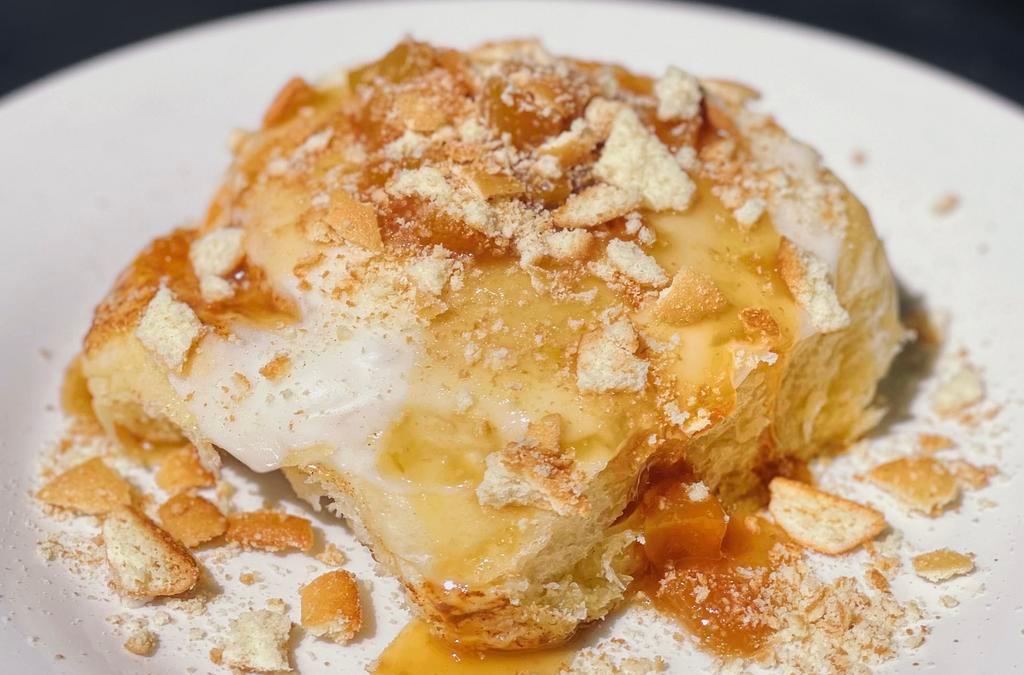 Peach Cobbler · Enjoy a homemade classic golden brown buttery, sweet and fluffy sweet roll. Topped with granny's secret scrumptious creamy, smooth one of a kind glaze and home made peach cobbler sauce and crushed vanilla cookies.