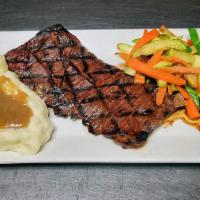 Beer Marinated Grilled Skirt Steak ·  Served with mashed potatoes and sautéed vegetables. 