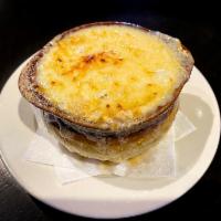 French Onion Soup · Our take on this classic is made with caramelized onions topped with baguette and covered wi...