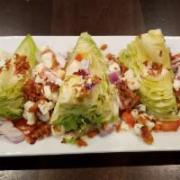 Wedge Salad · Gluten free. Iceberg lettuce with chunky blue cheese crumbles, crispy bacon, red onions and ...