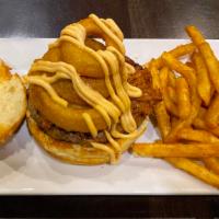 Here Piggy Piggy · A pile of pulled pork on top of a burger, onion rings, your choice of melted cheese, and
dre...