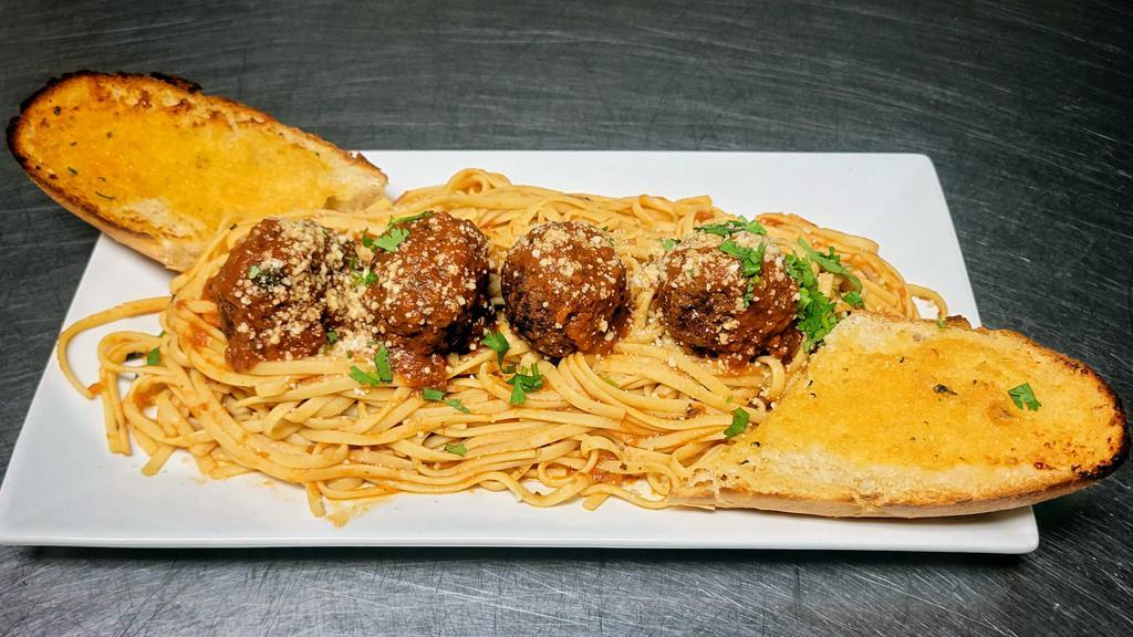 Linguini with Meatballs · Meatballs covered in marinara sauce and and parmesan cheese over a bed of linguini and served with toasted garlic bread.