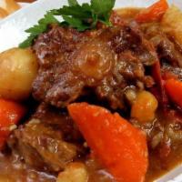Oxtail (Ke Bef) · Beef oxtail chopped and slowly cooked with onions and peppers to achieve maximum tenderness! 