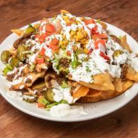 Nacho Overboard · Your choice of chicken, shrimp, or steak layered with lettuce, tomato, jalapeno, queso chees...