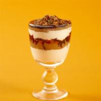Persian Parfait · Greek yogurt topped with pomegranate seeds, dates, tahini honey and crushed walnuts.