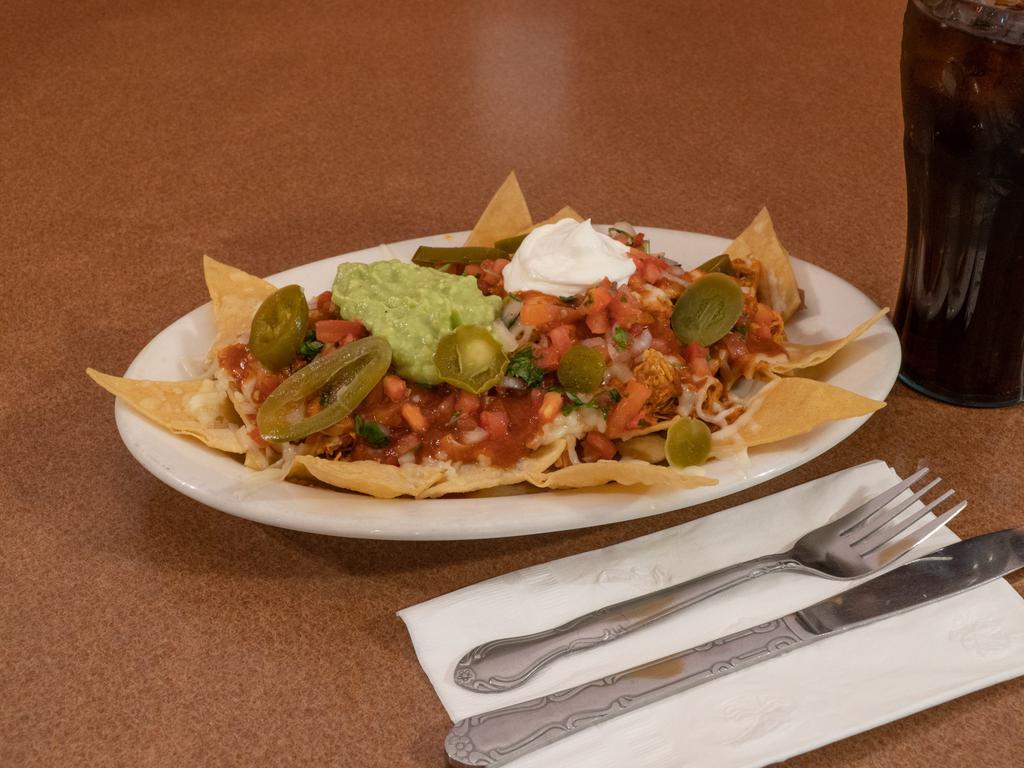 Nachos Supremos · Same as regular nachos, but upgraded with guacamole, sour cream, and your choice of ground beef, pork or chicken, or asada (steak), shredded beef, carnitas, and pastor for an additional charge.