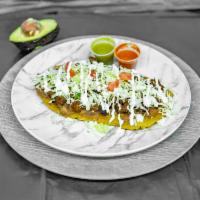Huarache · A thick homemade corn tortilla shared as sandal topped with choice meat, refried beans, cabb...