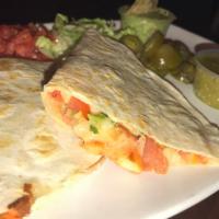 Shrimp Quesadilla Appetizer · Large flour tortilla stuffed with grilled shrimp, melted cheese and pico de gallo. Served w ...