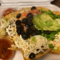 Ground Beef Taco Salad · Crisp flour shell filled with refried beans, lettuce and ground beef. Topped with shredded c...
