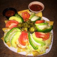 Small Botana · Corn chips covered with beans, chorizo and melted cheese. Topped with lettuce, tomato, green...