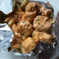 Fish N' Chips · Flavorful battered and deep fried salmon chunks with eatery sauce and fries.