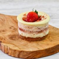 Strawberry Fields Cheesecake · Creamy vanilla filling with swirls of fresh California grown sweet strawberries and topped w...