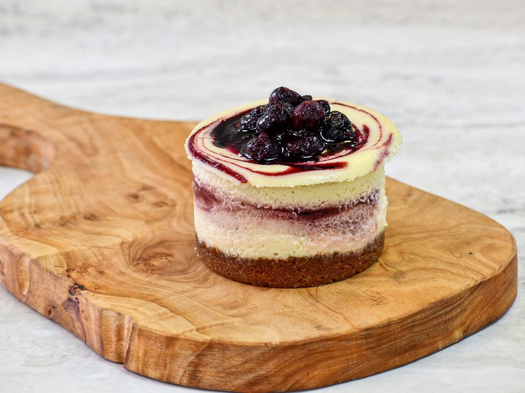 Beet & Berry Cheesecake · Our signature cheesecake — a creamy filling with delicious swirls of a fruit purée reduction made with roasted sweet beets, blueberries and red wine and topped with seasonal berry compote.