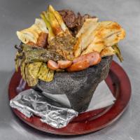 Molcajete de Carnes Taco · Grill chicken, steak, chorizo and sausage with grilled cactus and Panela cheese, served with...