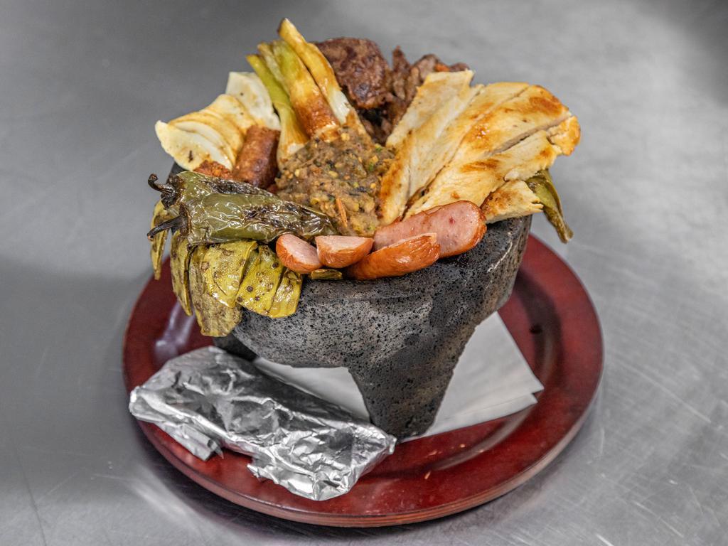 Molcajete de Carnes Taco · Grill chicken, steak, chorizo and sausage with grilled cactus and Panela cheese, served with a delicious molcajete sauce cambray onios and a grilled jalapeno pepper. Accompanied with Mexican rice, beans and corn tortilla.